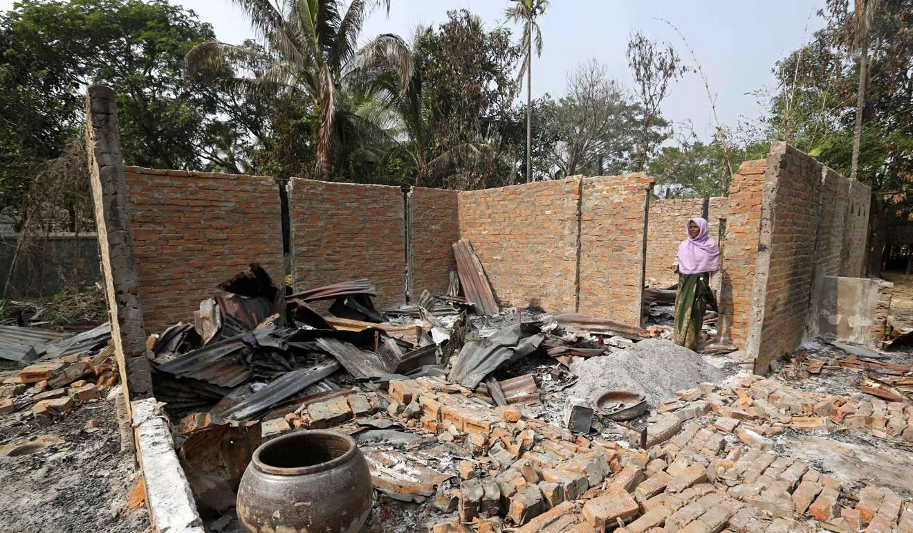A Muslim woman stands inside a damaged house in Pyaung Bate village, which was burnt down during the conflict near the Maungdaw town near the Bangladesh-Myanmar border in Rakhine State. Photo: EPA