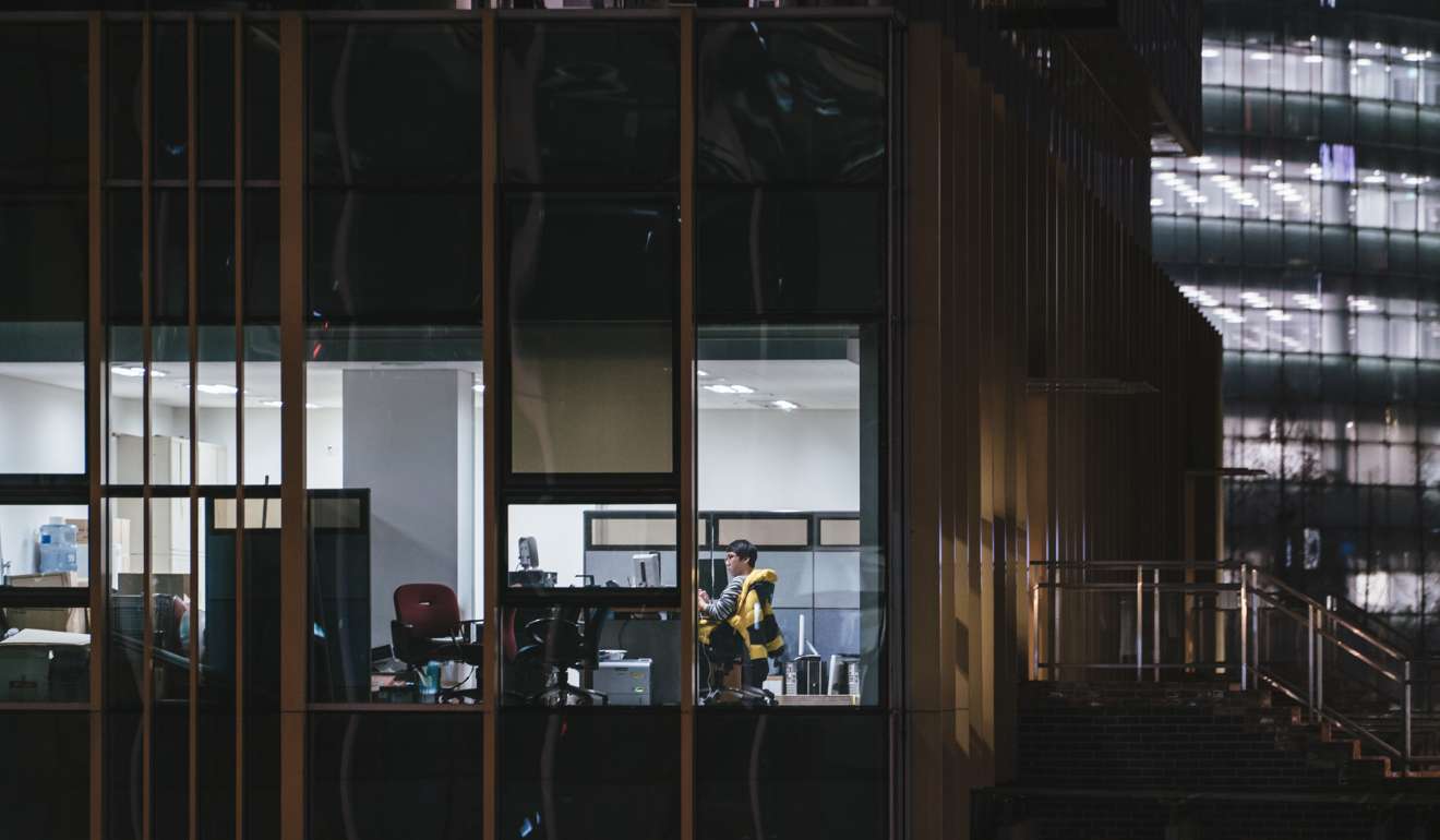 Flexible work arrangements can help lower rates of staff turnover. A lone office worker is doing an overtime shift in downtown Seoul. Photo: The Washington Post