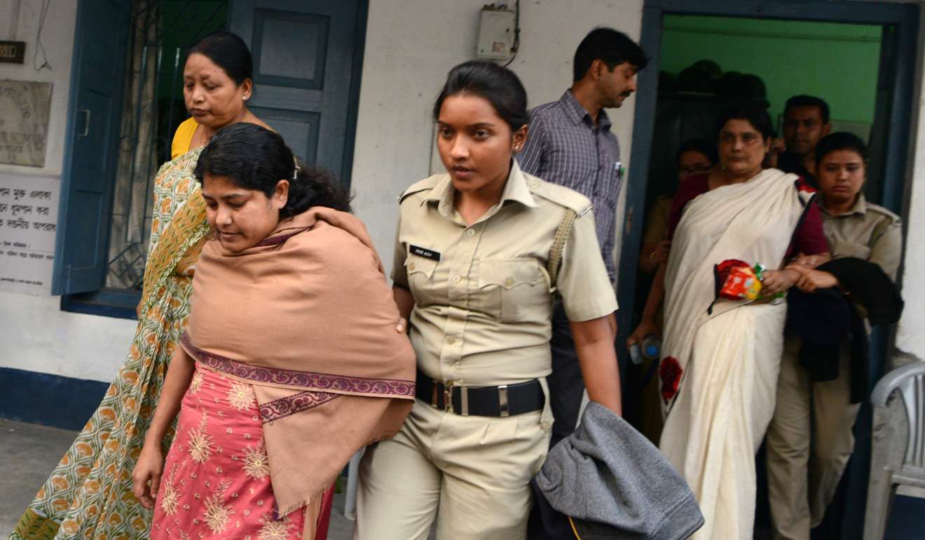 Indian police officials escort Chandana Chakraborty and Sonali Mondal from a police station in Jalpaiguri in the eastern Indian state of West Bengal, after their arrest as part of an alleged child-trafficking scandal. Photo: EPA