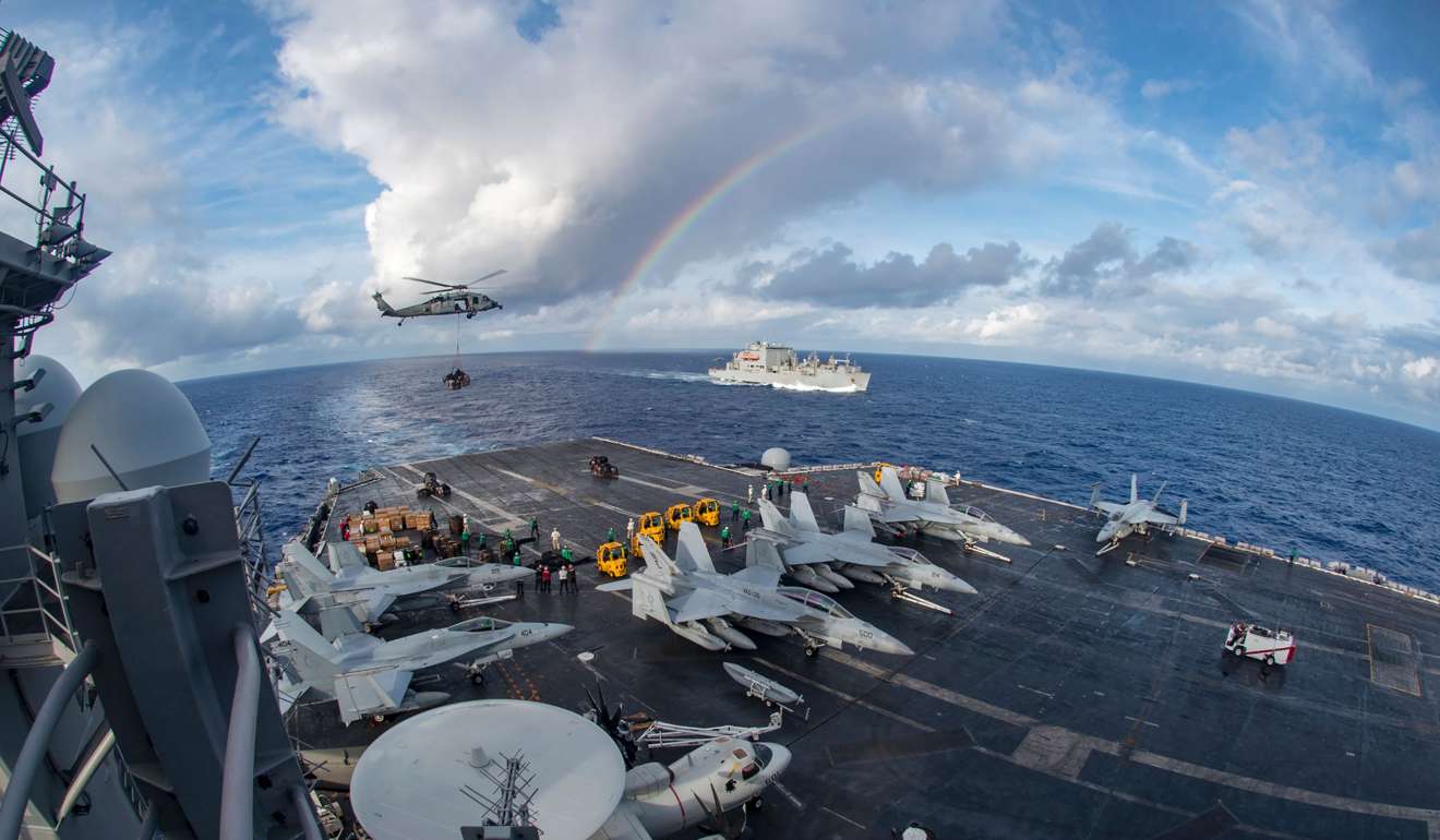 The aircraft carrier USS Carl Vinson participating in a replenishment-at-sea with the Black Knights of Helicopter Sea Combat Squadron 4 and the cargo and ammunition ship USNS Charles Drew in the Pacific Ocean. Photo: US Navy via AFP