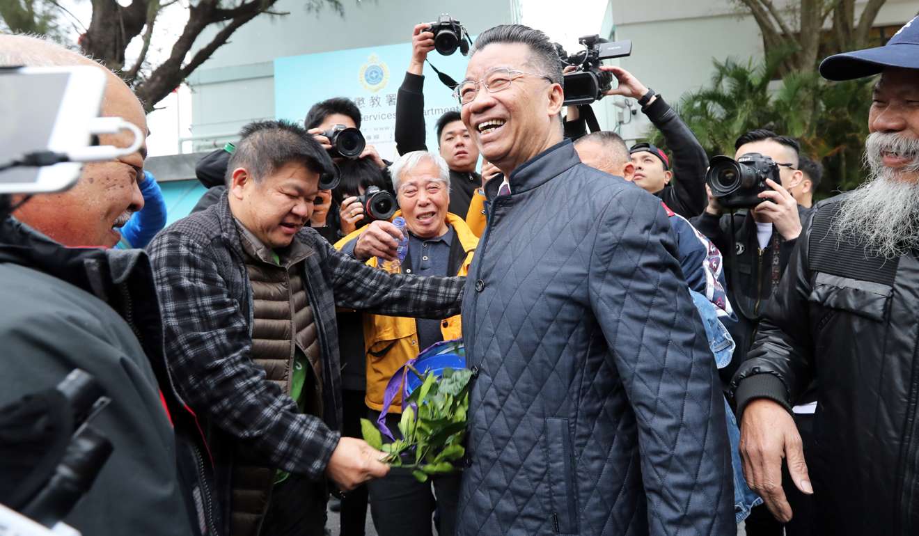 Businessman Lew Mon-hung’s friends with pomelo leaves to help him “wash off” bad luck. Photo: Edward Wong