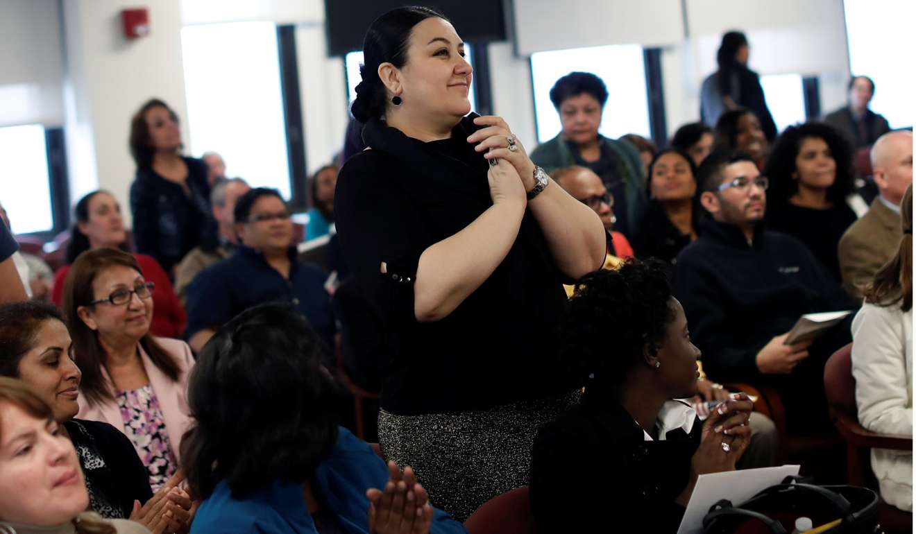 A woman stands as names are called to receive certificates of US citizenship during a naturalisation ceremony in Newark, New Jersey, on Wednesday. Religious tolerance, if not assimilation, is likely to endure, anti-immigrant xenophobia notwithstanding. Photo: Reuters