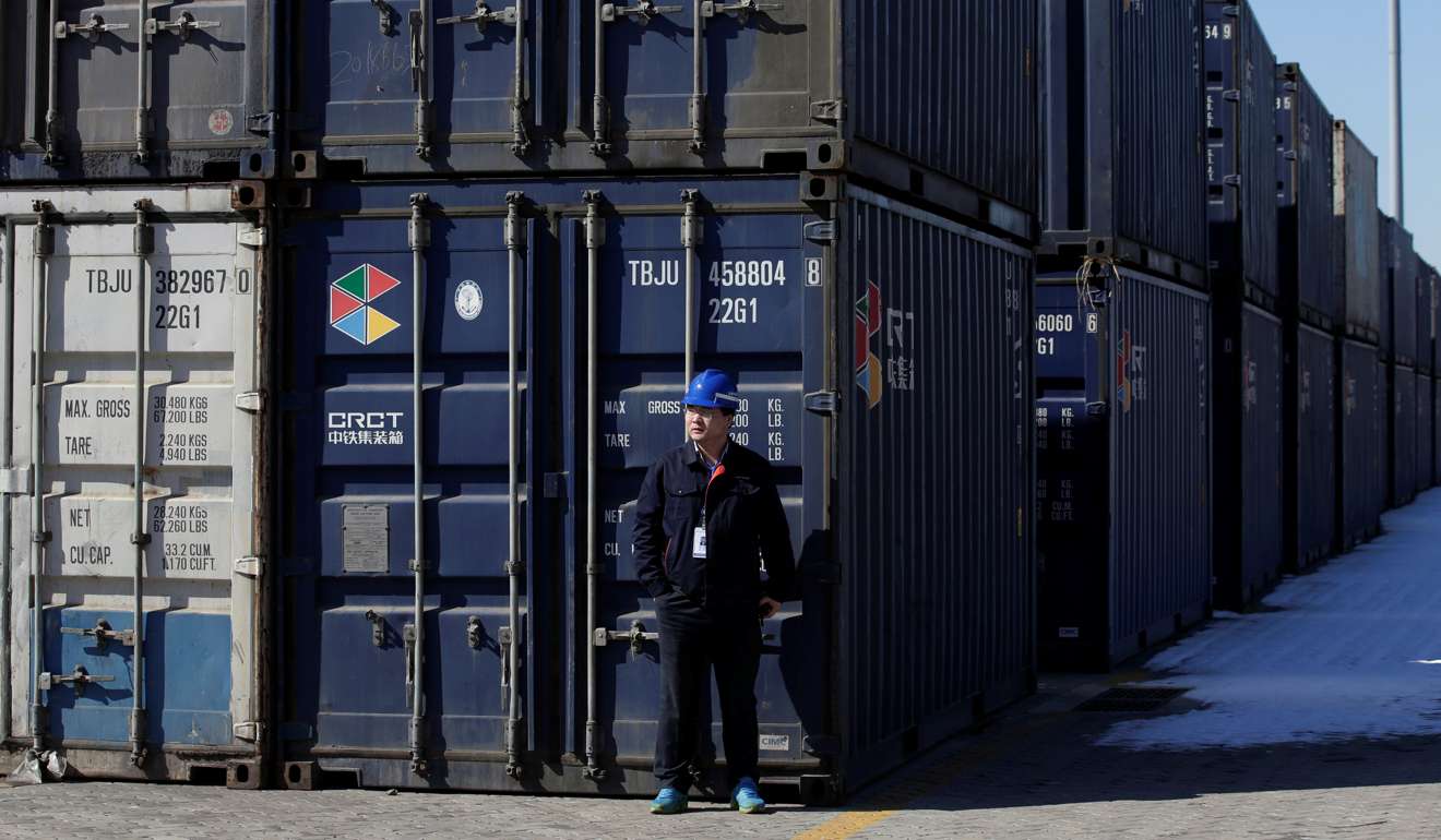 A worker stands next to containers near the Tianjin port. On this side of the Pacific, no one should be lulled by Trump’s endorsement of the “one China” policy. Photo: Reuters