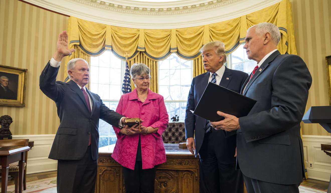 US Vice-President Mike Pence (right) swears in Attorney General Jeff Sessions while Sessions' wife, Mary Blackshear Sessions and US President Donald Trump look on in the Oval Office of the White House on February 9. Photo: EPA