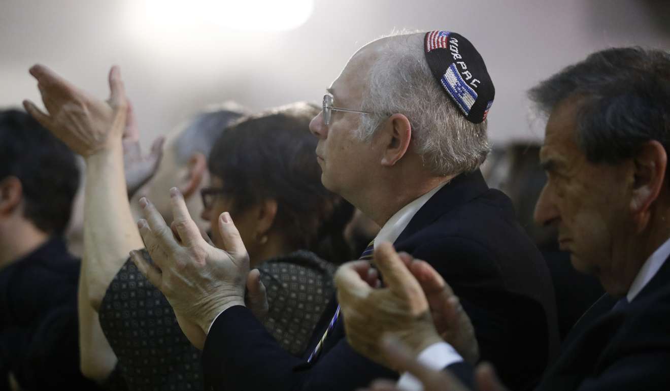 People clap as New Jersey Governor Chris Christie delivers remarks at the Kaplen Jewish Community Centre on the Palisades during a rally against recent bomb threats made to Jewish centres. Photo: AP