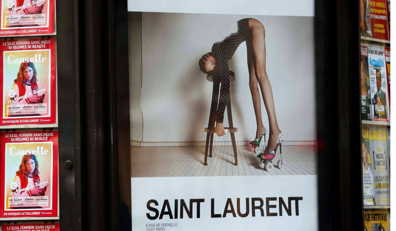 An ad by French fashion house Yves Saint Laurent is seen on a newspaper kiosk in Paris. Photo: Reuters