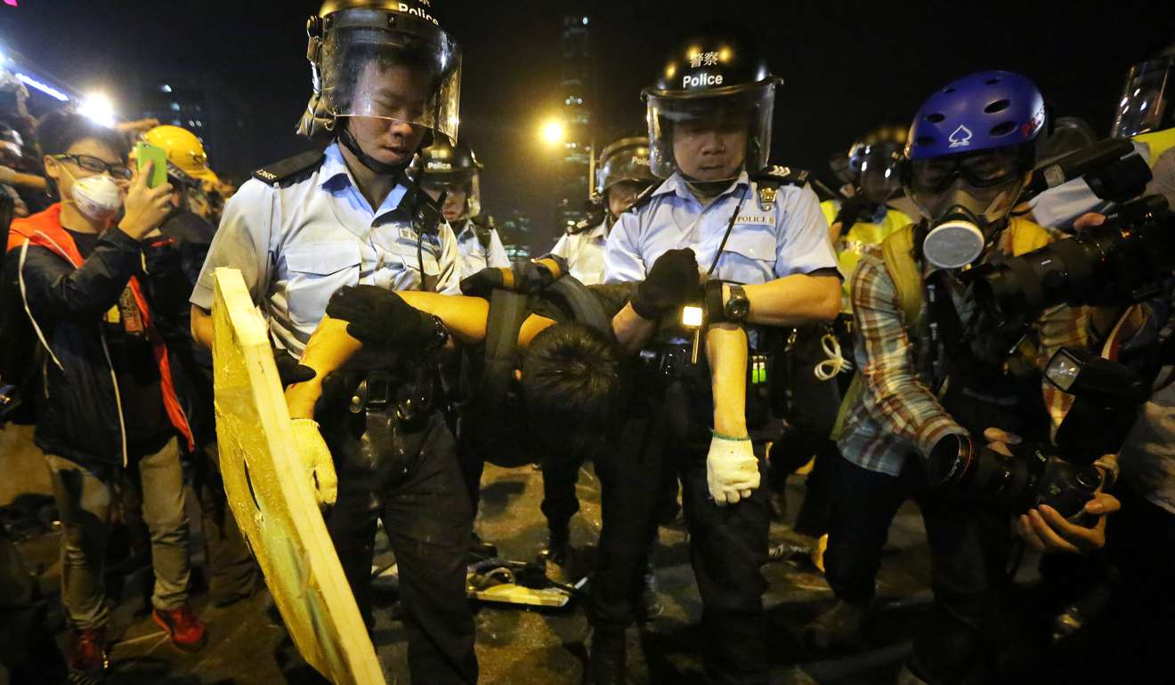 Police officers arrest a pro-democracy protester during the Occupy Central protests in November 2014. Photo: Sam Tsang