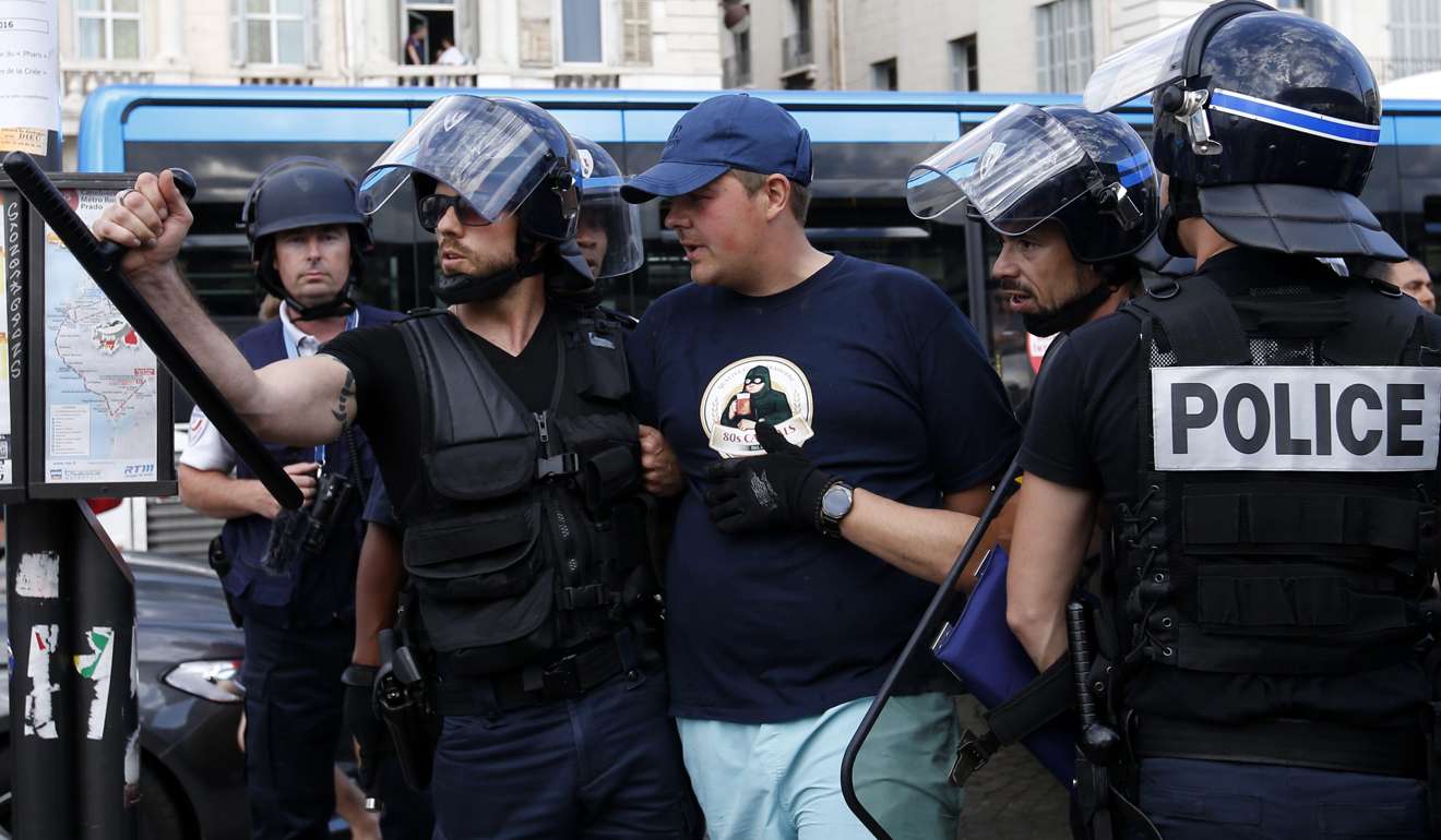 Riot police arrest a man after clashes bewteen English and Russian supporters during Euro 2016. Photo: EPA