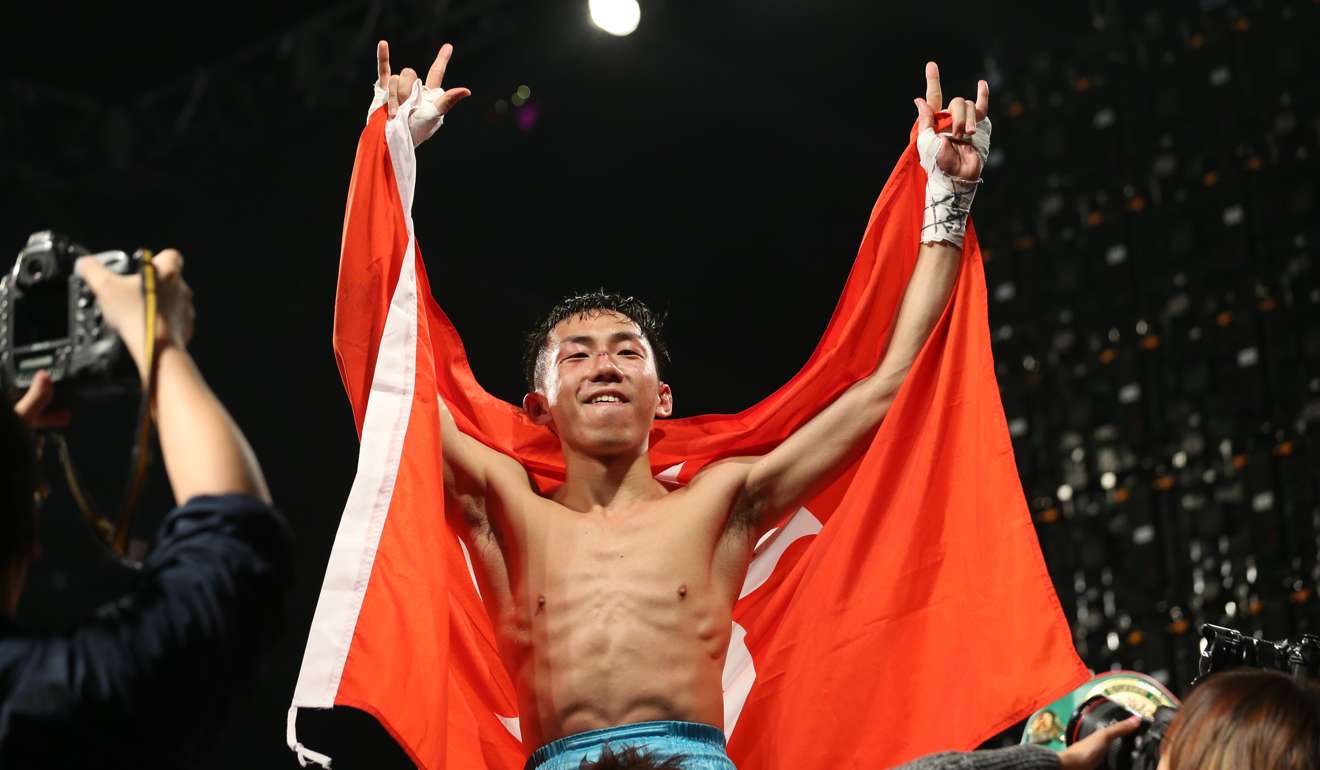 Rex Tso celebrates with the Bauhinia flag after his victory. Photo: Felix Wong