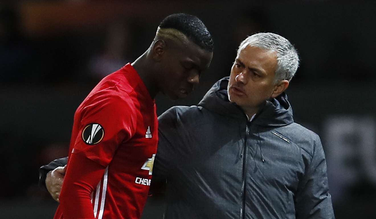 Paul Pogba walks off to be substituted after sustaining an injury as manager Jose Mourinho speaks to him. Photo: Reuters