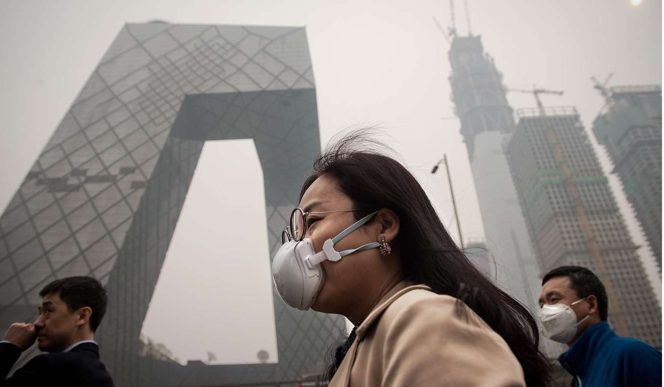 People in Beijing wear protective masks on Monday, when the city was enveloped in smog. Despite its rapid growth, China is still a developing country and its domestic landscape is fraught with political perils, economic uncertainties and other problems, including environmental challenges. Photo: AFP