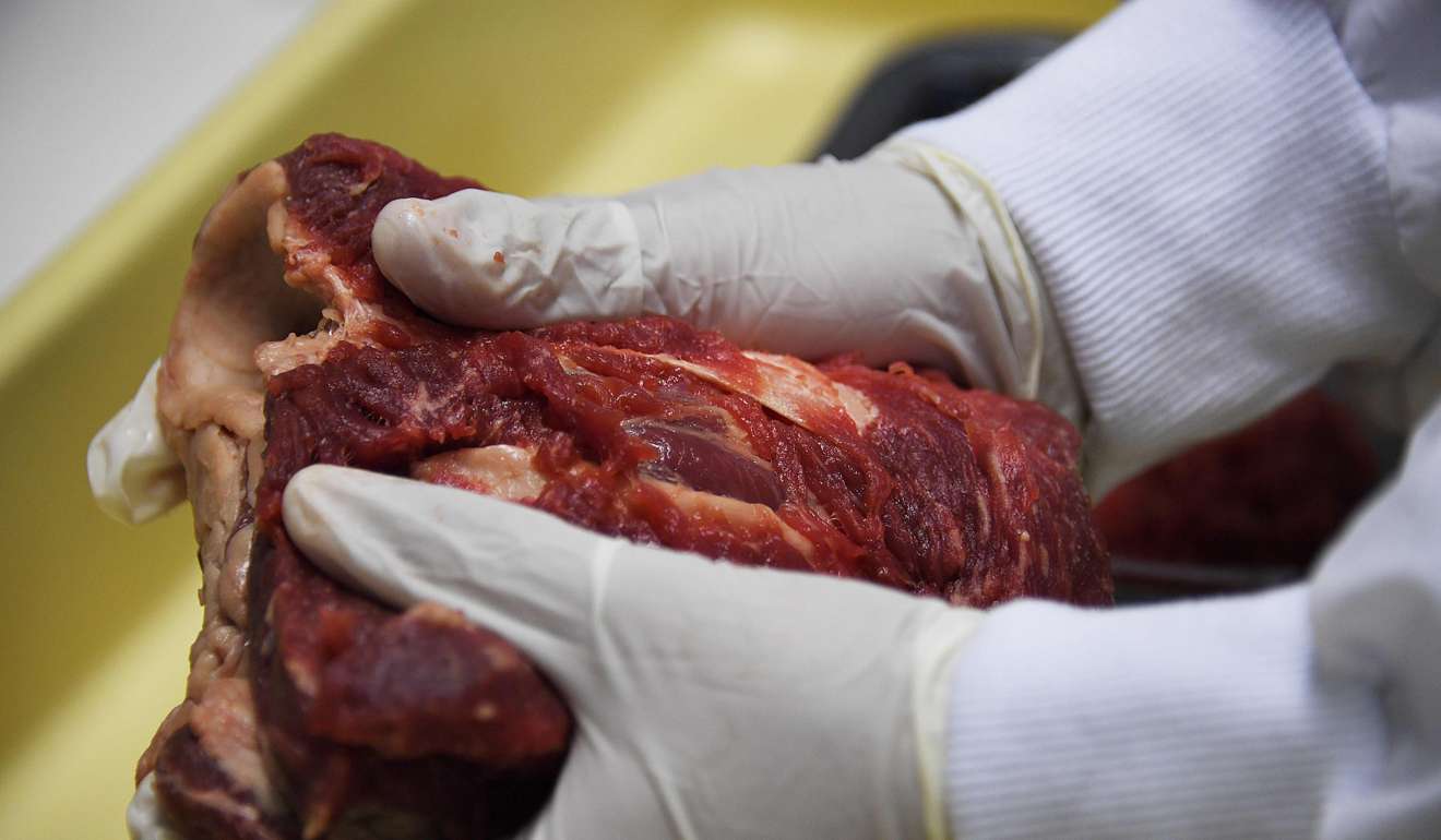 Animal meat seized at a market in Rio de Janeiro, Brazil, being inspected on Monday. Photo: AFP