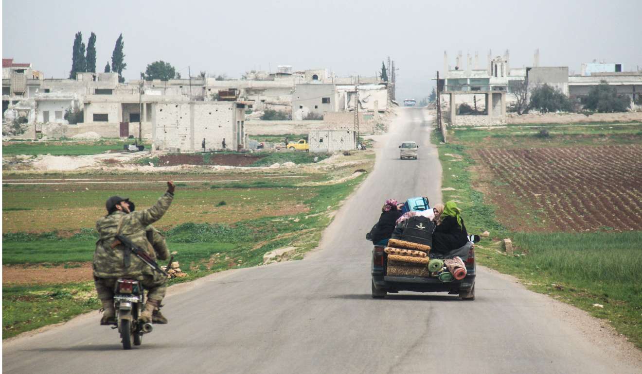 A displaced Syrian family travels down a road with their belongings on Wednesday as two rebel fighters drive past on a motorbike, near the town of al-Lataminah in the countryside of the central Syrian province of Hama. Beijing sees democratisation as dangerous and potentially destabilising; they look at the Arab spring, the civil war in Syria and Mikhail Gorbachev’s glasnost. Photo: AFP