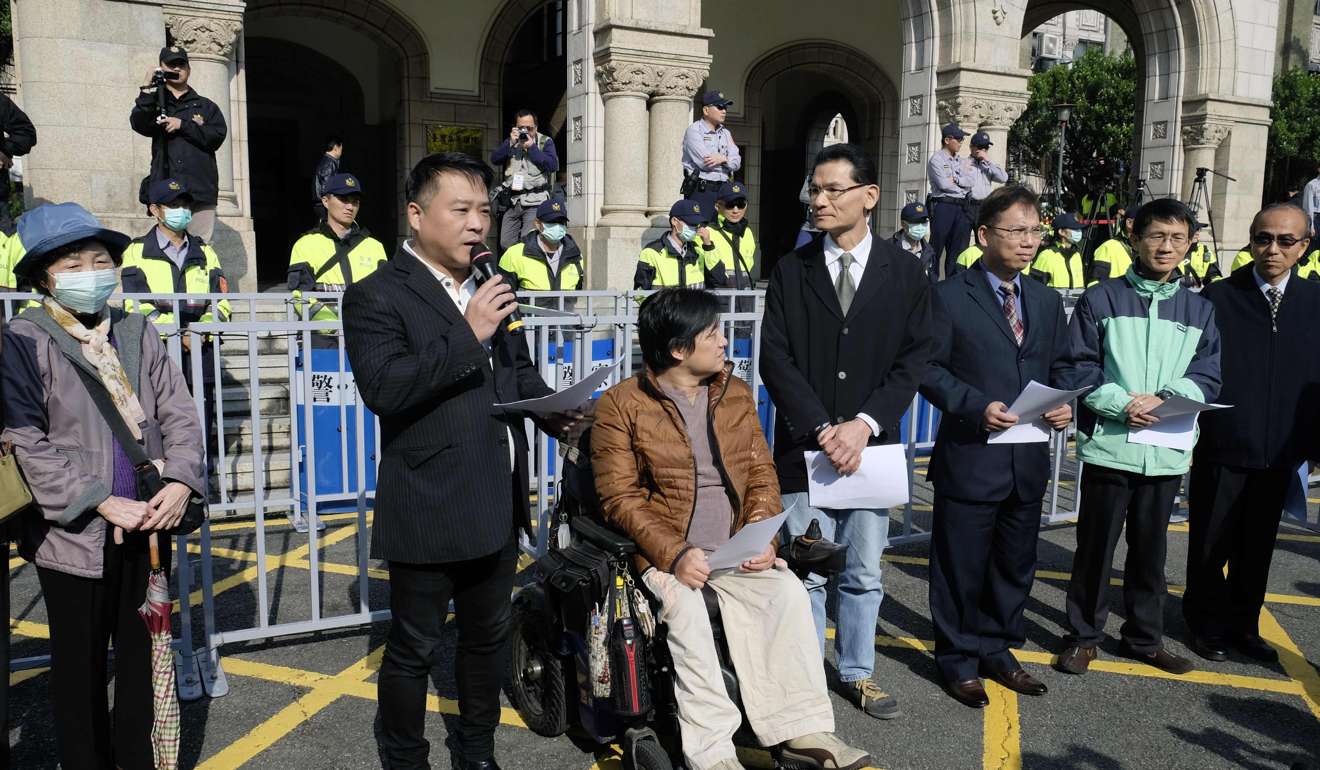 Opponents of same-sex marriage speak to the press outside the Judicial Yuan in Taipei on Friday. Photo: AFP