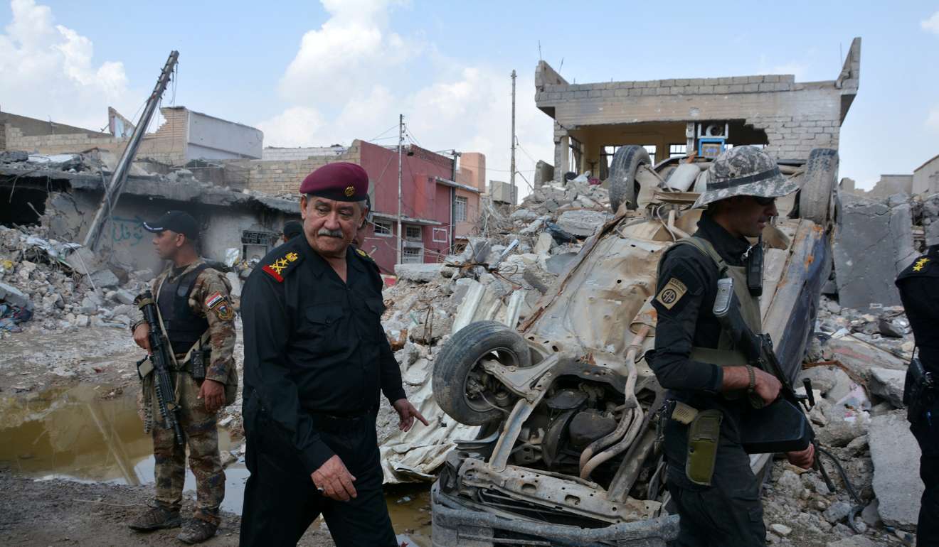 Major General Abdul Ghani al-Asadi, a commander of the Counter Terrorism Service (CTS) walks at the site after an air strike attack against Islamic State triggered a massive explosion in Mosul. A suicide truck bombing killed 15 people in the capital of Baghdad. Photo: Reuters