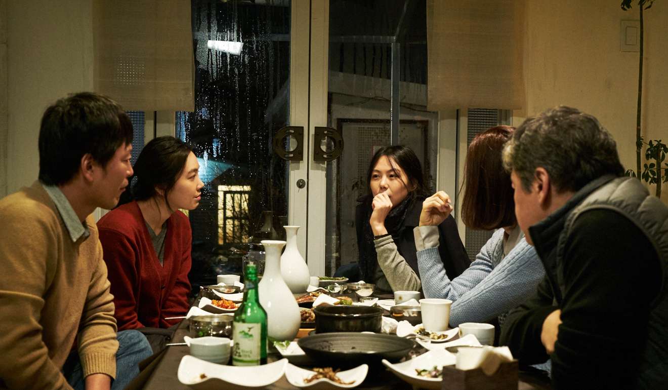 Kim Min-hee (middle) in a dinner scene from On the Beach at Night Alone.