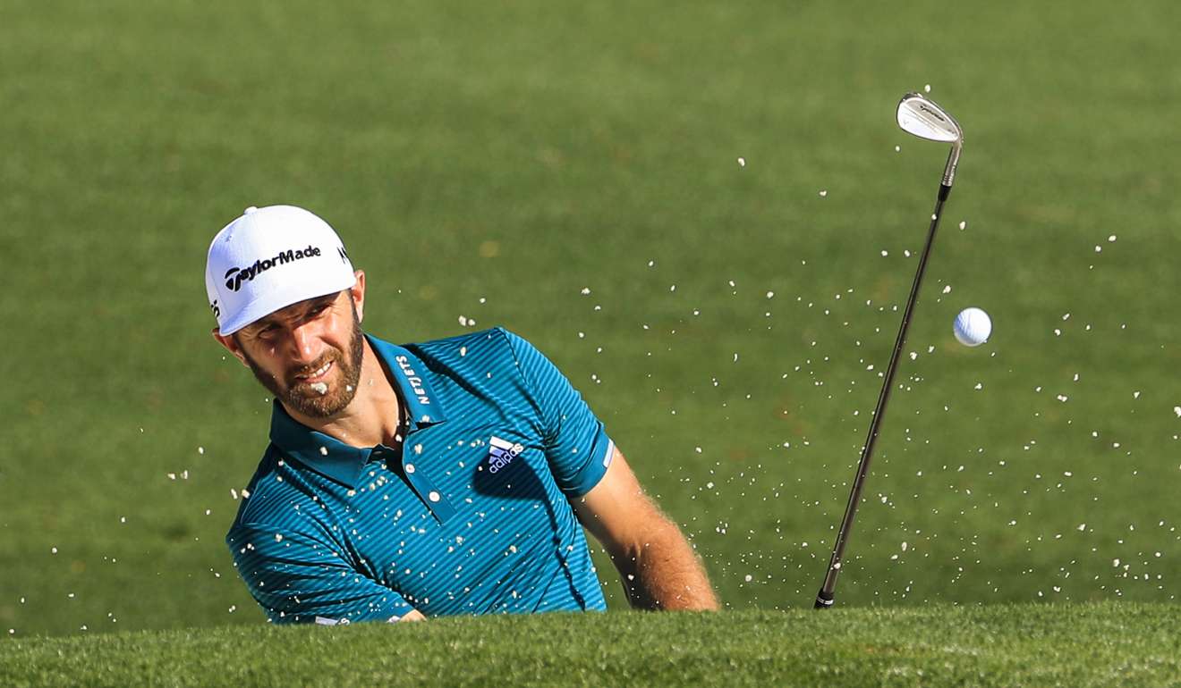 Dustin Johnson hits from a bunker during a practice round ahead of the Masters. Photo: EPA