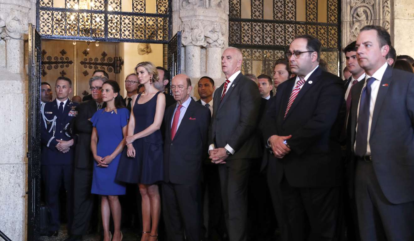 Ivanka Trump, the daughter and assistant to President Donald Trump, third from left, stands next to Commerce Secretary Wilbur Ross as they listen to President Donald Trump speaks about the US missile attack on Syria at Mar-a-Lago on Thursday. Photo: AP