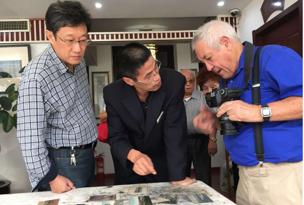 From left: Lin Weibin, Victor Wei and Ian Gill with Lin’s collection of postcards. Picture: courtesy of Hao Youlin