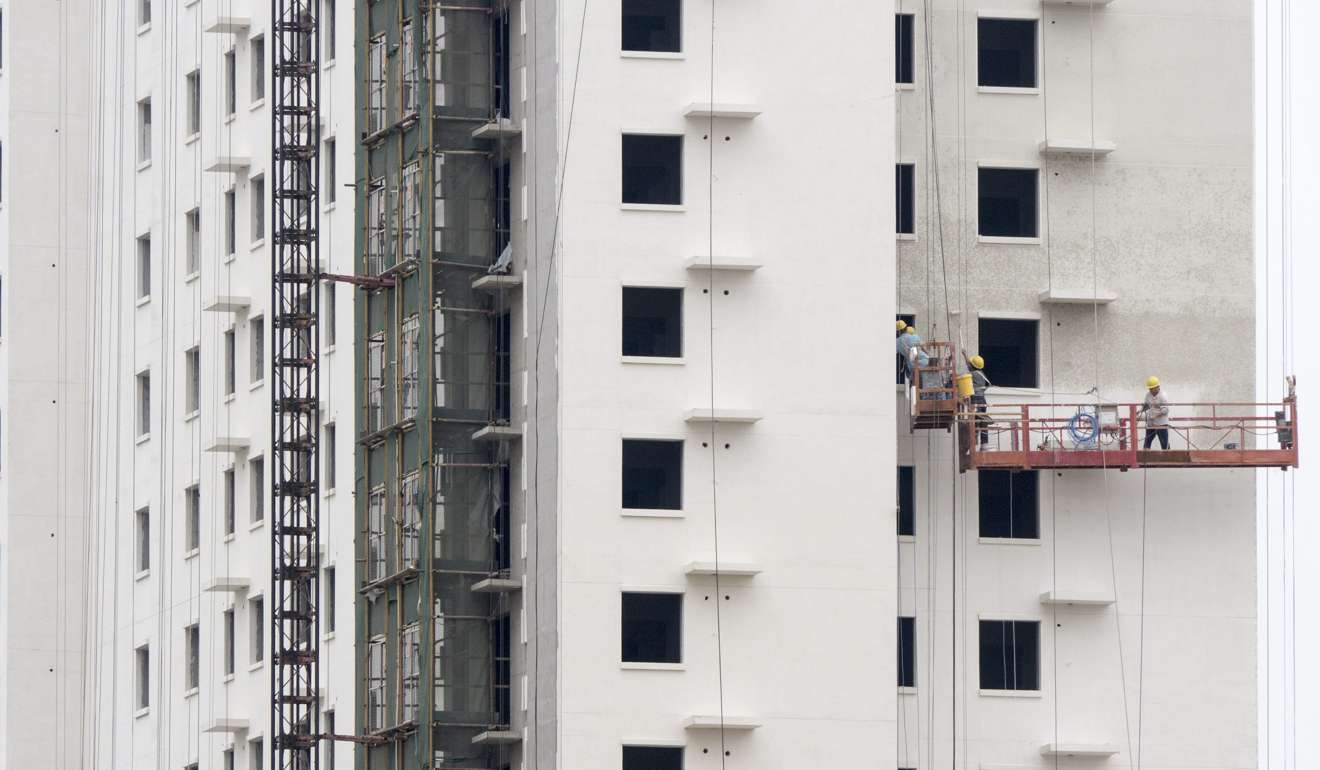 Workers construct housing in the suburbs of Beijing. The pull on the Chinese economy towards housing investments means a push away from consumption. Photo: EPA