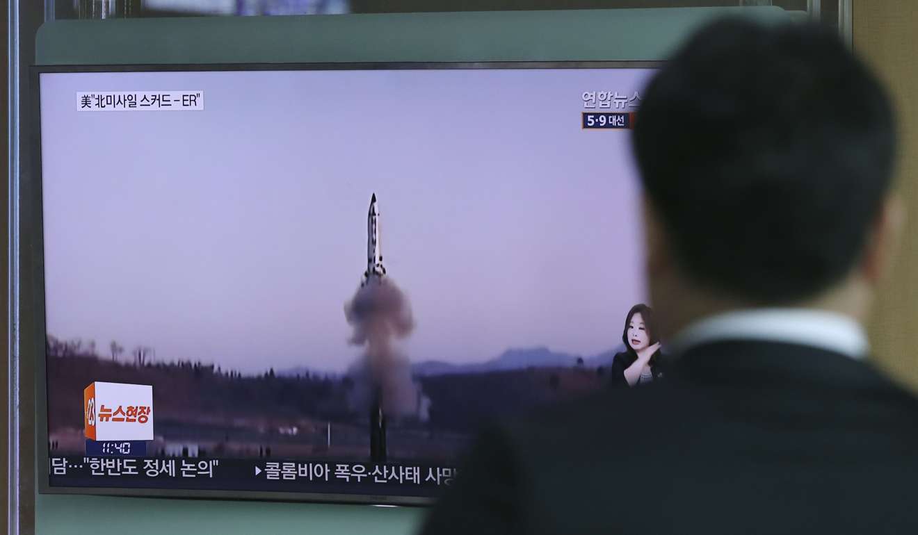 A man watches a news report on a North Korean rocket launch at Seoul Train Station. The issue promised to be the most neuralgic issue in the Florida meetings. Photo: AP