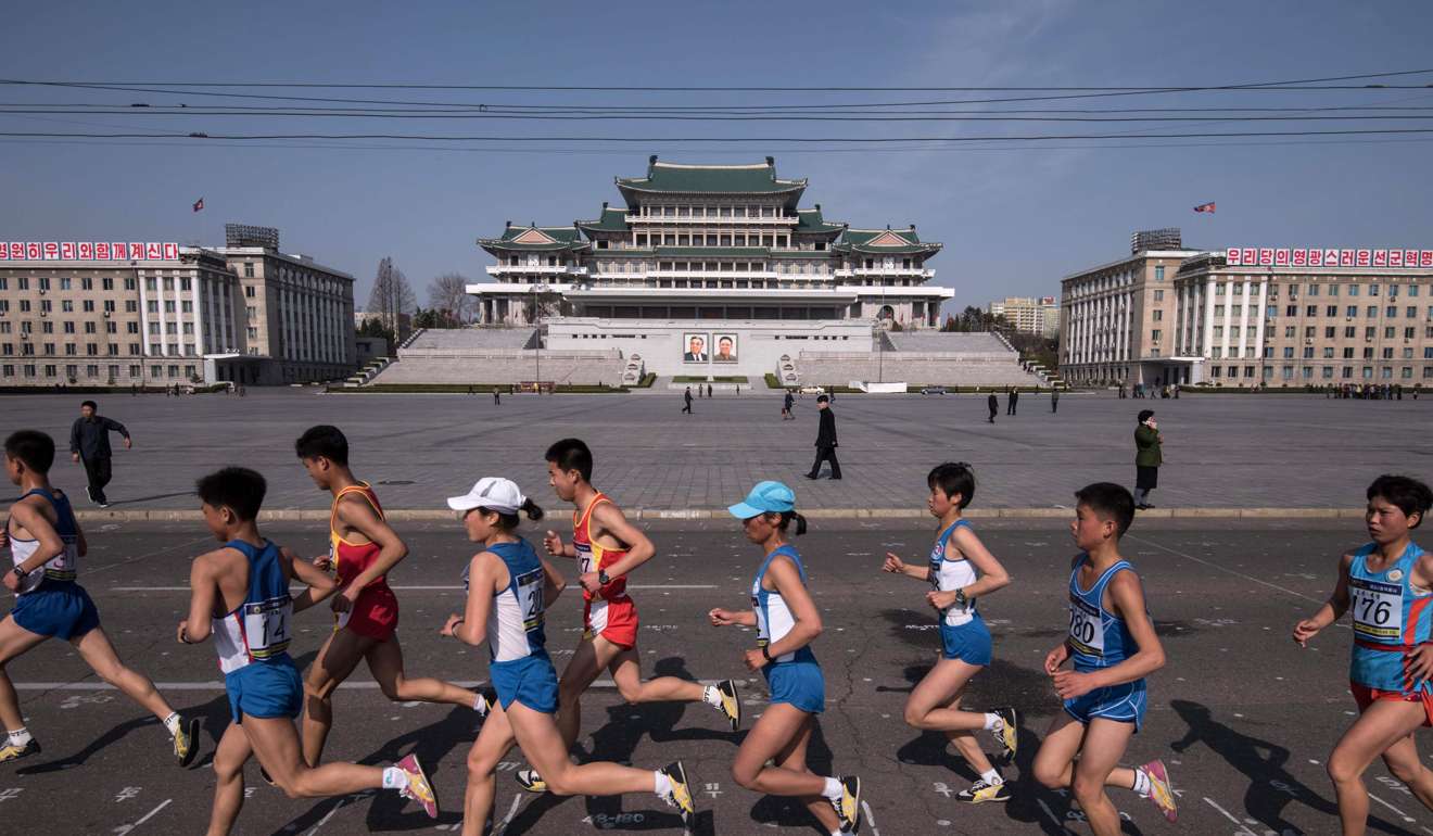 Competitors run through Kim Il-Sung square during the Pyongyang Marathon. Photo: AFP