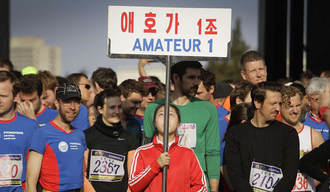 Runners wait to be led into the Kim Il-sung Stadium for the start of the Pyongyang marathon. Photo: AP