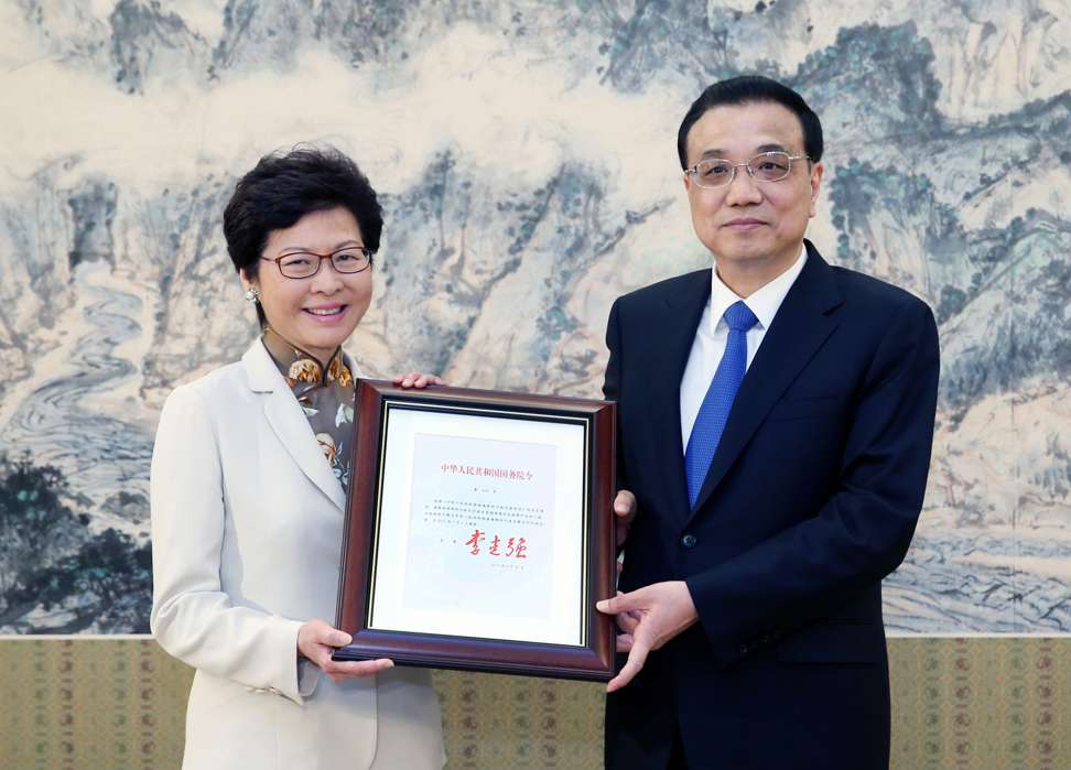 Chief executive-elect Carrie Lam is given her certificate of appointment by Premier Li Keqiang. Photo: Xinhua