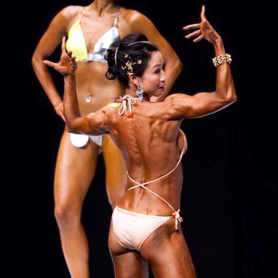 Behind the scenes of a female bodybuilder showing off her back