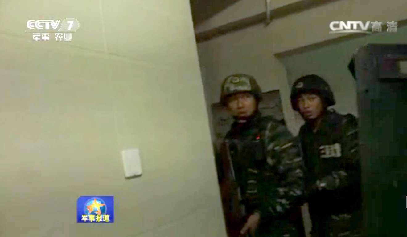 Armed police taking part in the raid. Photo: CCTV