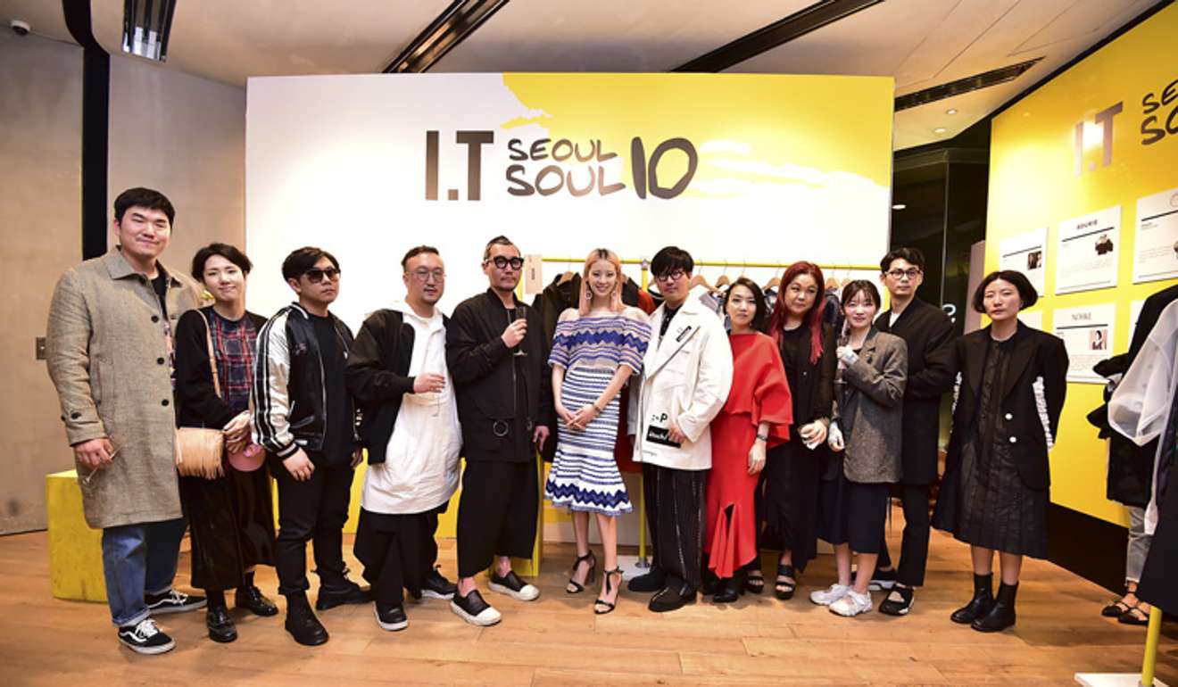 Korean fashion designers Park Hwan-sung of D-ANTIDOTE, third from left, Kang Dong-jun of D.GNAK, fifth from the left, Han Hyun-min of Munn, seventh from the left, and Jung Mi-sun of Nohke, eighth from the left, pose during the pop-up exhibition ‘Seoul's 10Soul’ at fashion brand house I.T. in Hysan One in Hong Kong. Photo: Seoul Design Foundation