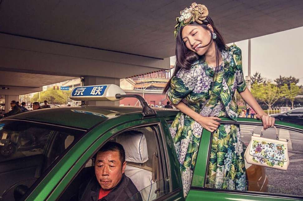 Model in green dress with poker-faced green-taxi driver, shot for Dolce & Gabbana’s social media campaign. Photo: Instagram/Dolce & Gabbana