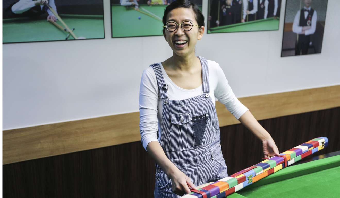 Ng On-yee is delighted with her three major titles as she displays her checkered cue stick.