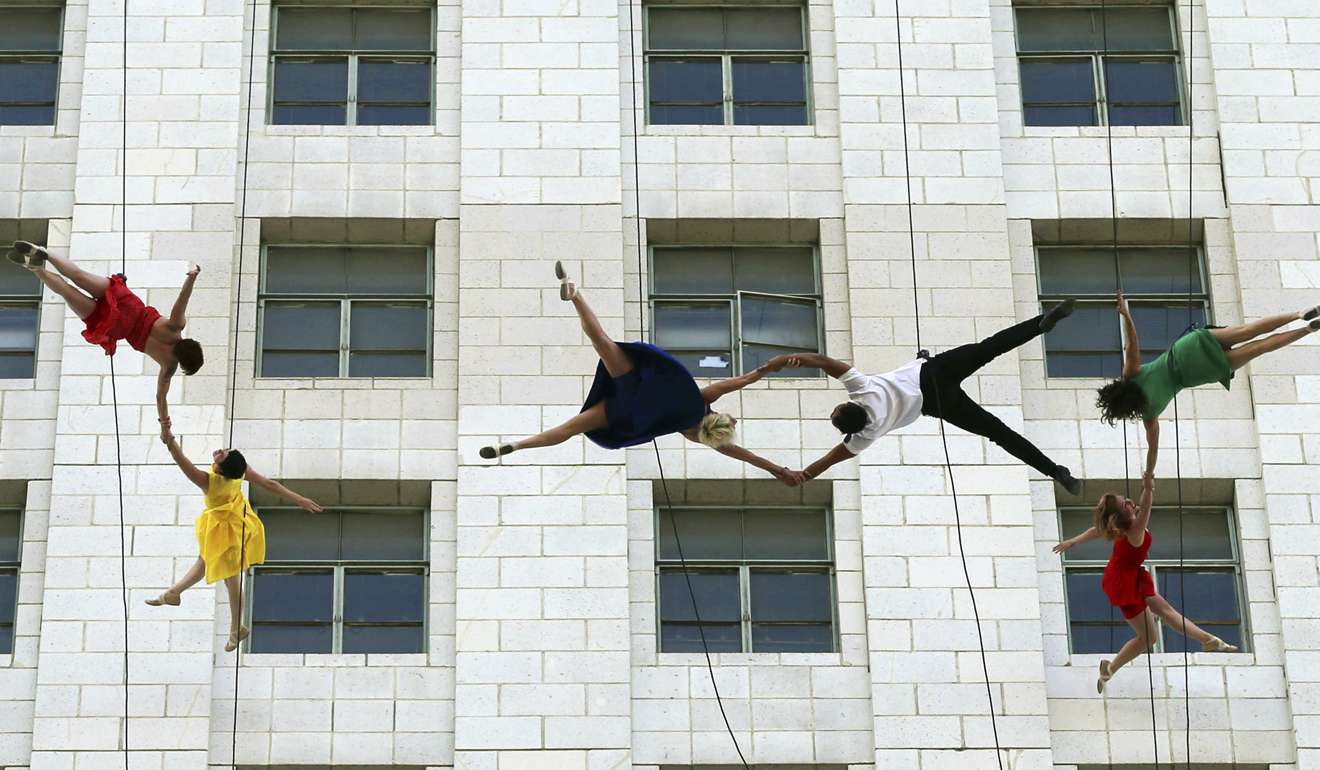 Dancers from Bandaloop aerial dance troupe perform to a medley of songs and dances from the movie