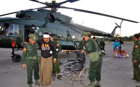 Soldiers help people injured in fighting in Lashio, northern Myanmar, on Sunday. Photo: EPA