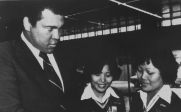 Muhammad Ali playfully glares at two women security guards as they check his travel documents at Hong Kong’s Kai Tak airport in December 1979 while on his way to mainland China. Photo: AP