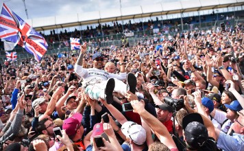 Lewis Hamilton crowd-surfs with the fans after winning the British Formula One Grand Prix. AFP