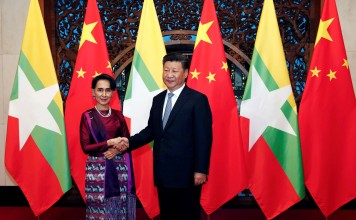 Myanmar State Counsellor Aung San Suu Kyi and President Xi Jinping pose for the media before their meeting at the Diaoyutai State Guesthouse in Beijing on August 19. Photo: Reuters