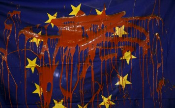 Protesters threw red paint on a European Union flag in protest against the European policy on refugees at Madrid's landmark Puerta del Sol square in Spain in March last year, and 2017 is unlikely to be any easier. Photo: Reuters