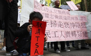 A young boy holds up a “fai chun” saying “cancel TSA”, at a protest against Chief Executive Leung Chun-ying’s performance, outside Government House on January 30. Photo: Nora Tam