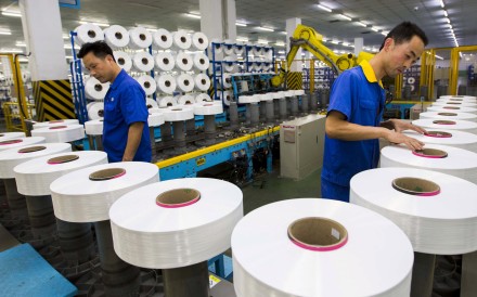 Employees work along a production line of a textile factory in Suzhou, Jiangsu province, China, June 13, 2015. China's factory sector contracted by the most in 15 months in July as shrinking orders depressed output, a preliminary private survey showed on July 24, 2015. Picture taken June 13, 2015. REUTERS/China Daily CHINA OUT. NO COMMERCIAL OR EDITORIAL SALES IN CHINA