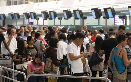 Passenger queue at Hong Kong International Airport on Monday. Photo: K. Y. Cheng