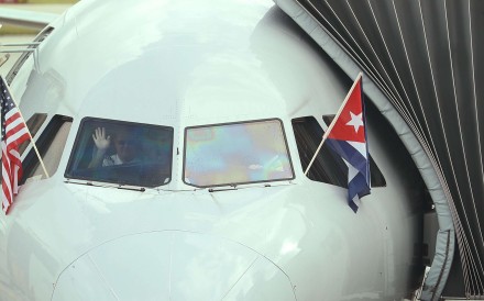 A pilot waving as he prepares to push back from the gate in American Airlines Flight 903, becoming the first commercial flight from Miami to Cuba in 55 years, in Miami, Florida in September. Photo: AFP