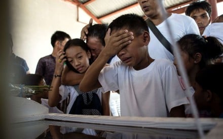 The son of an alleged drug user cries in front of his father’s casket before the burial in the north of Manila, on March 12. The father was gunned down by unidentified men. Photo: AFP The son of an alleged drug user cries in front of his father’s casket before the burial in the north of Manila, on March 12. The father was gunned down by unidentified men. Photo: AFP