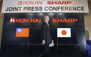 Kozo Takahashi, president of Sharp Corp, walks past a podium after speaking following a takeover agreement with Taiwan's Hon Hai Technology Group in Osaka. Photo: EPA Kozo Takahashi, president of Sharp Corp, walks past a podium after speaking following a takeover agreement with Taiwan's Hon Hai Technology Group in Osaka. Photo: EPA