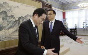 China's Premier Li Keqiang, right, directs Japanese Foreign Minister Fumio Kishida to a meeting at the Zhongnanhai leadership compound in Beijing on Saturday. Photo: AP)