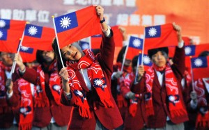 Performers hold up the Taiwan flag during a flag-raising ceremony in Taipei. Cross-strait ties have deteriorated since Taiwanese President Tsai Ing-wen took office. Photo: AFP