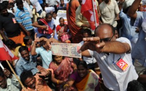A member of the Communist Party of India displays a 1000 rupee note during a protest against Indian Prime Minister Narendra Modi and the withdrawal of the high-value banknotes from circulation. Photo: AFP/Arun Sankar A member of the Communist Party of India displays a 1000 rupee note during a protest against Indian Prime Minister Narendra Modi and the withdrawal of the high-value banknotes from circulation. Photo: AFP/Arun Sankar