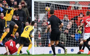 Arsenal's Olivier Giroud heads home a late equaliser to snatch a 1-1 draw with Manchester United at Old Trafford. Photo: AFP