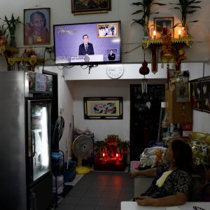 A woman watching Thai Prime Minister Prayuth Chan-ocha during his weekly broadcast. Photo: Reuters